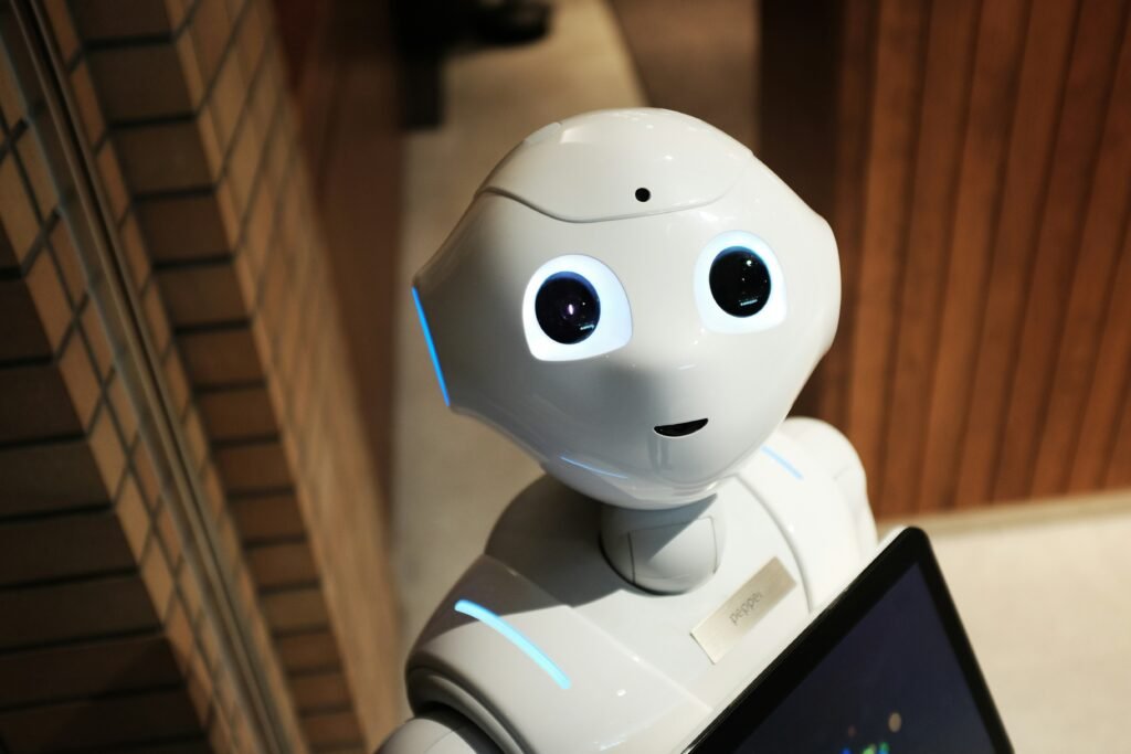 white robot near brown wall white robot near brown wall